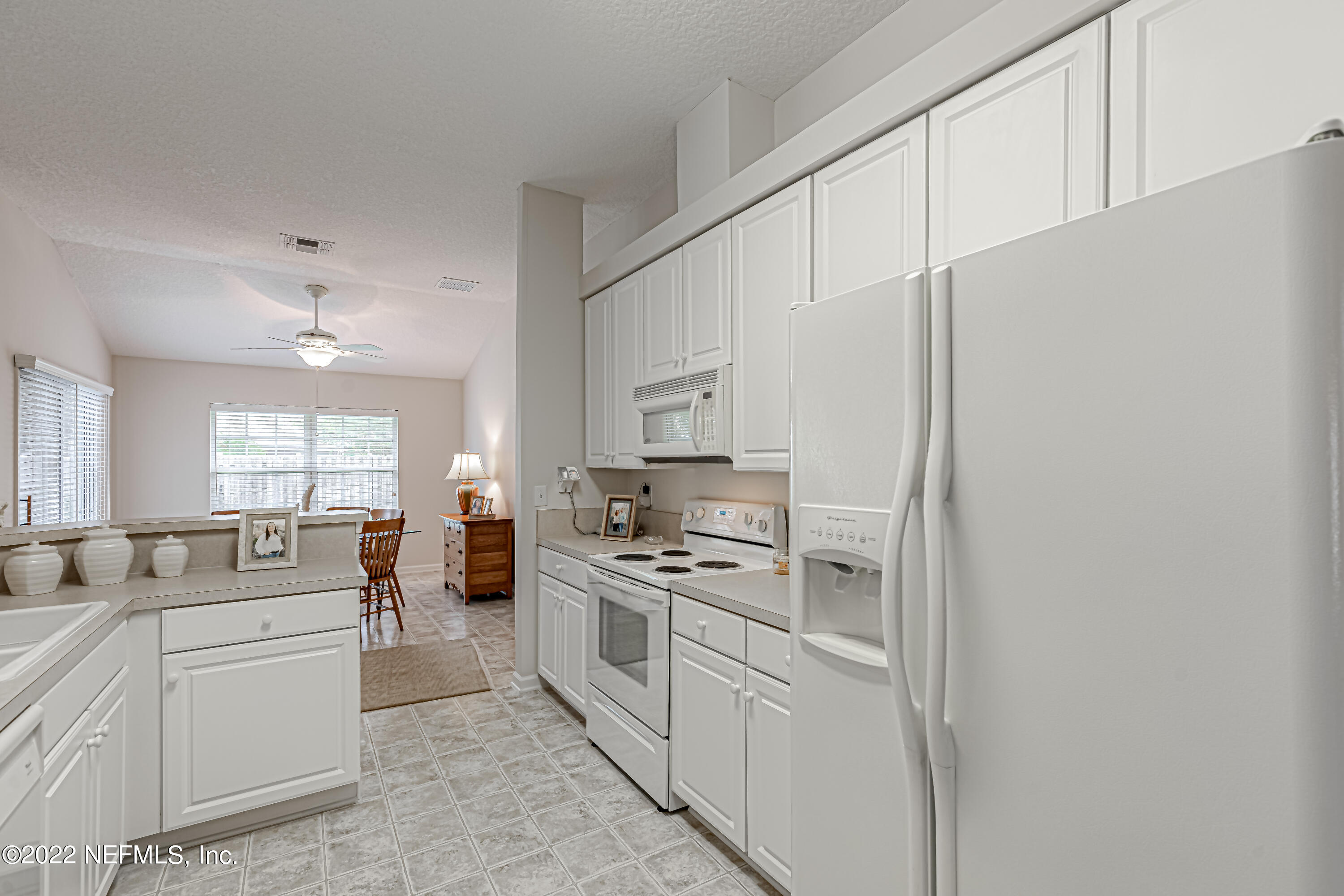 124 Dragonfly Drive Jacksonville, FL 32259 - Photo 19 of 40 a kitchen with white cabinets and white appliances