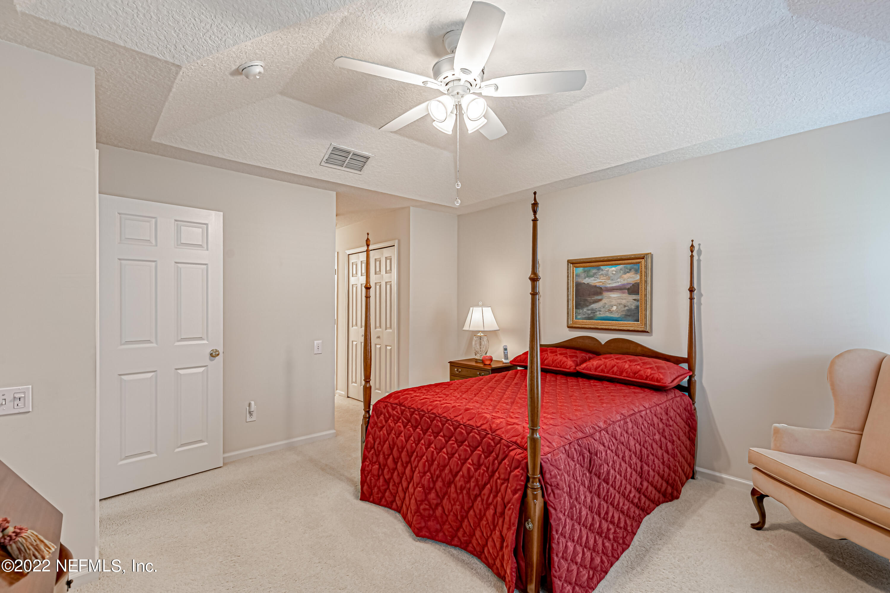 124 Dragonfly Drive Jacksonville, FL 32259 - Photo 23 of 40 a bedroom with a bed and a chandelier