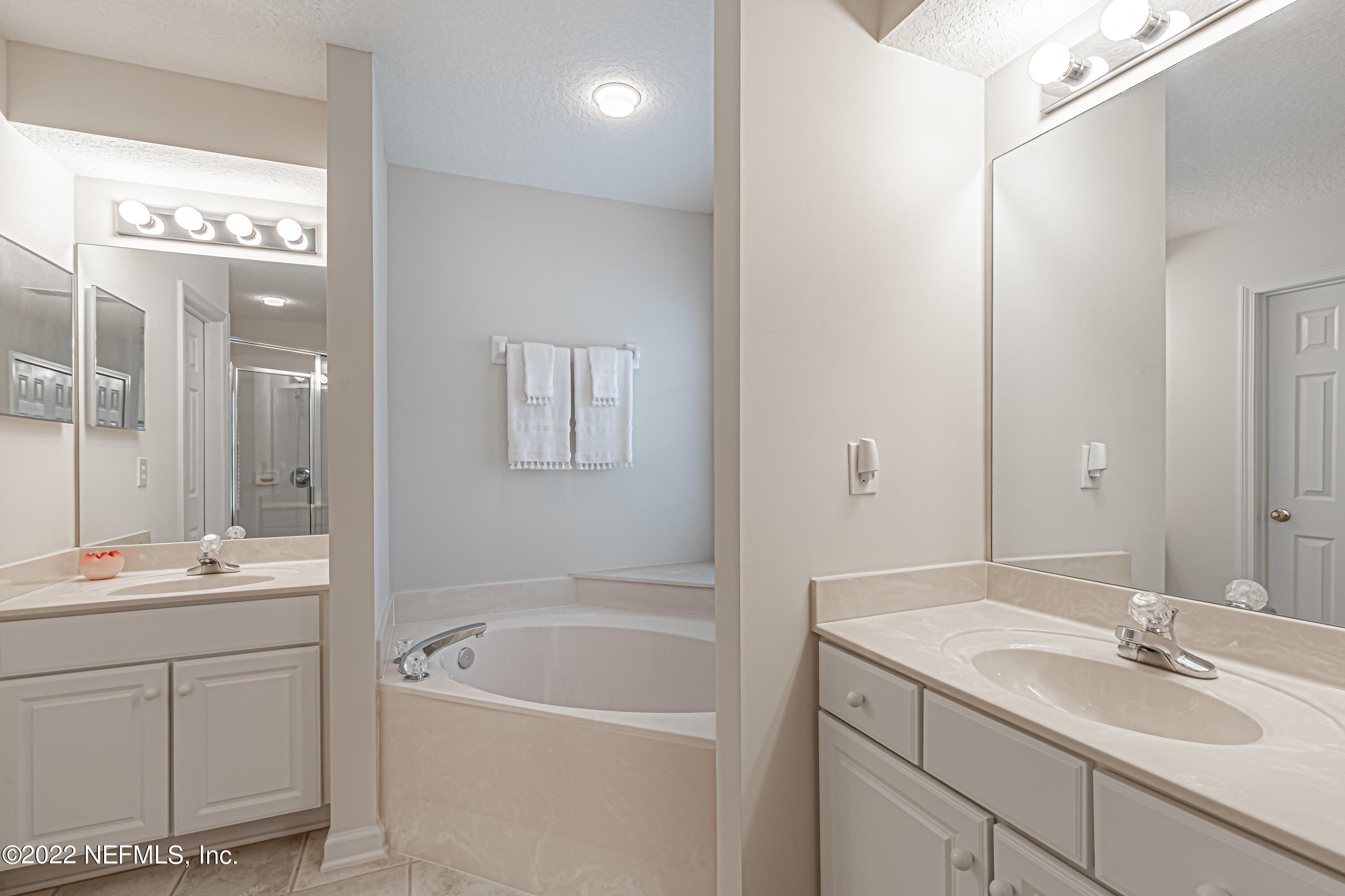 124 Dragonfly Drive Jacksonville, FL 32259 - Photo 26 of 40 a bathroom with a tub sink double vanity and mirror