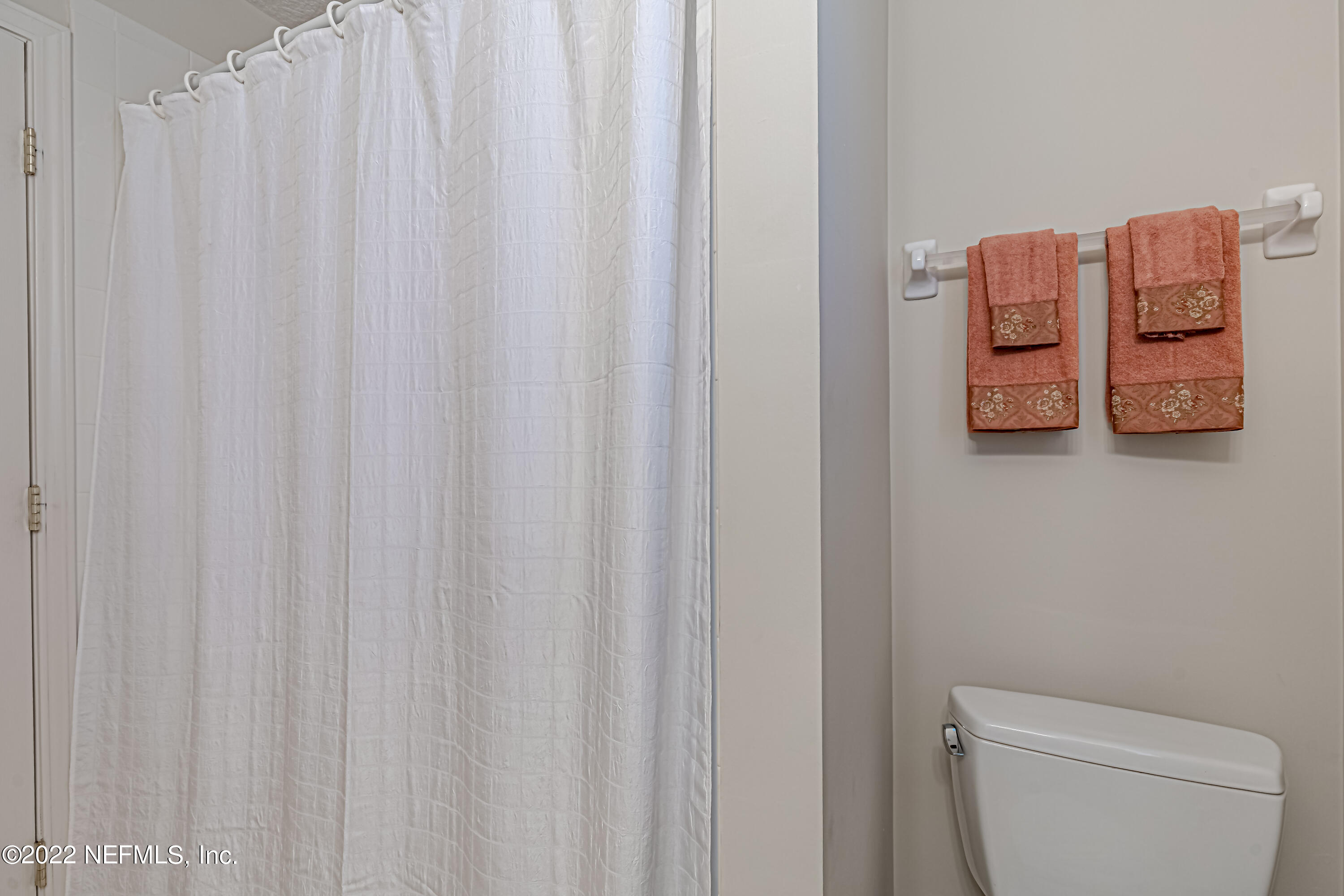 124 Dragonfly Drive Jacksonville, FL 32259 - Photo 32 of 40 a white toilet sitting next to a shower curtain