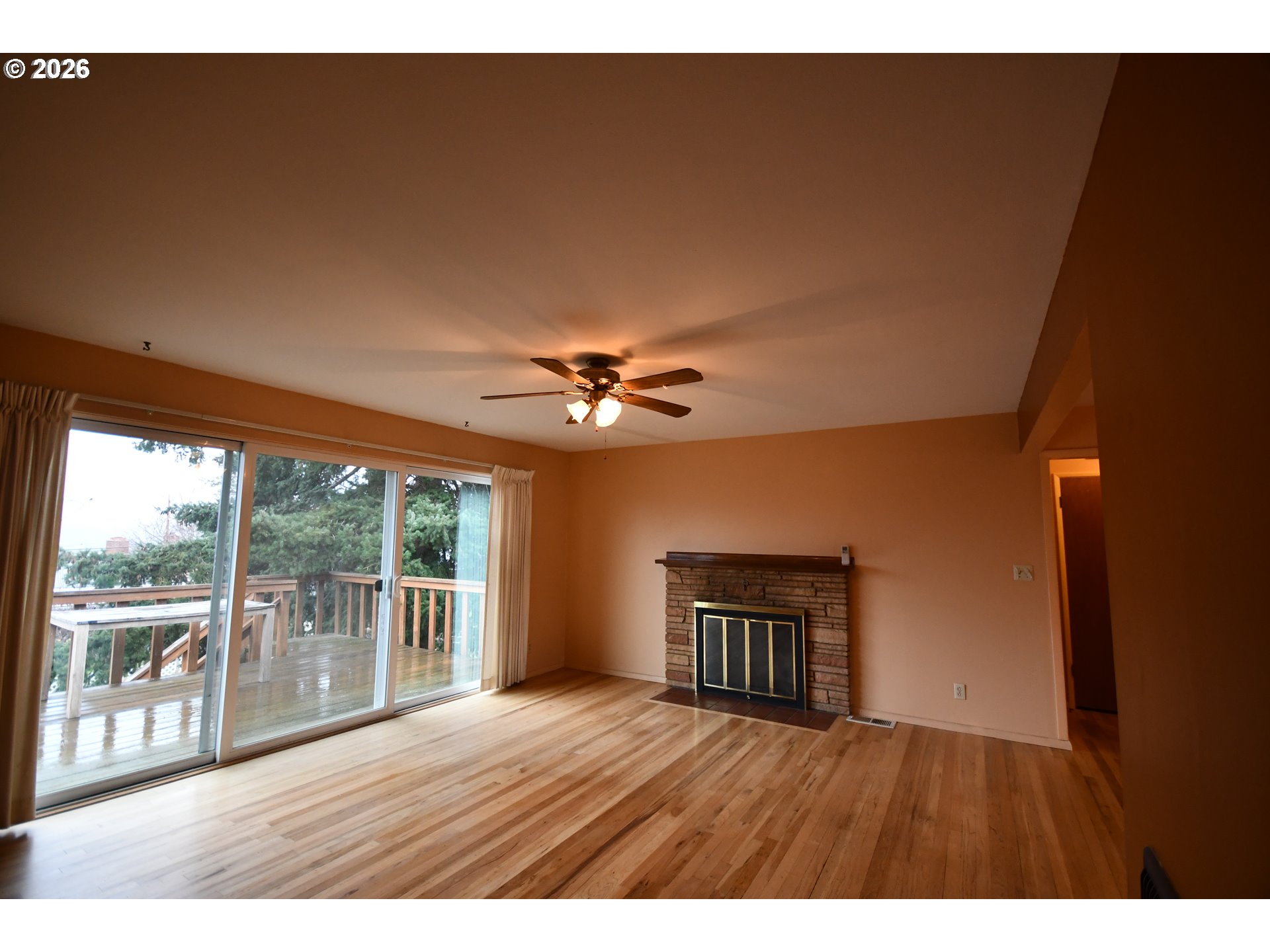 731 East 19th Street The Dalles, OR 97058 - Photo 13 of 42 a view of an empty room with a window and wooden floor