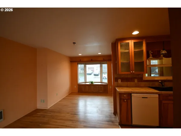 a kitchen with a sink and wooden floor