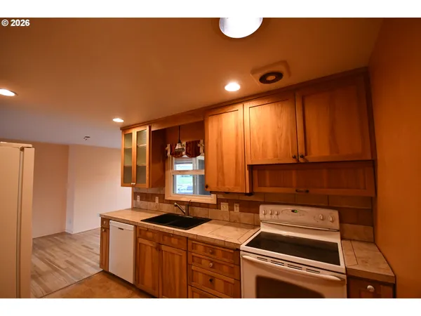 a kitchen that has a sink and a stove