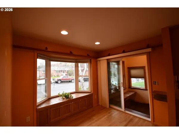 a view of hallway with a large window and kitchen view