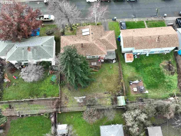 an aerial view of a house with a yard