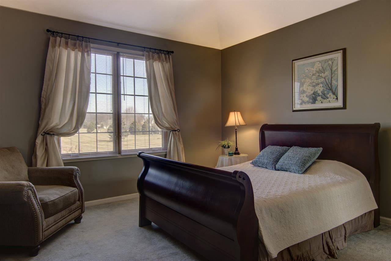 12210 Bellingham Road Caledonia, IL 61011 - Photo 14 of 24 a bedroom with a bed and a couch next to a window
