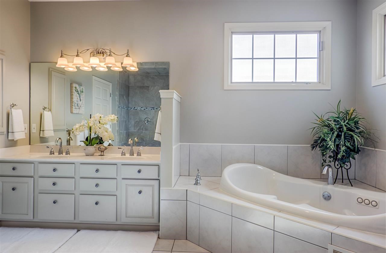 12210 Bellingham Road Caledonia, IL 61011 - Photo 15 of 24 a bathroom with a tub sink and mirror