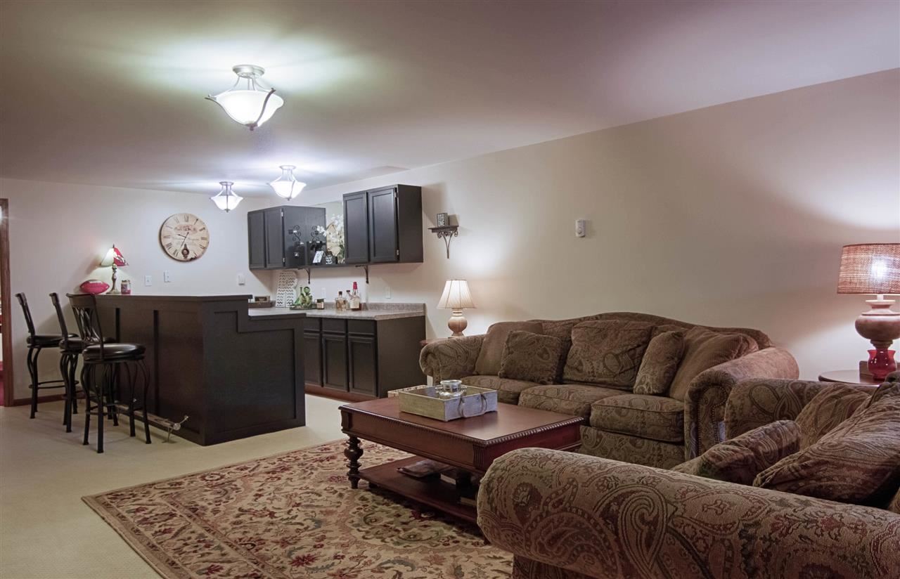 12210 Bellingham Road Caledonia, IL 61011 - Photo 19 of 24 a living room with furniture a dining table and a fireplace