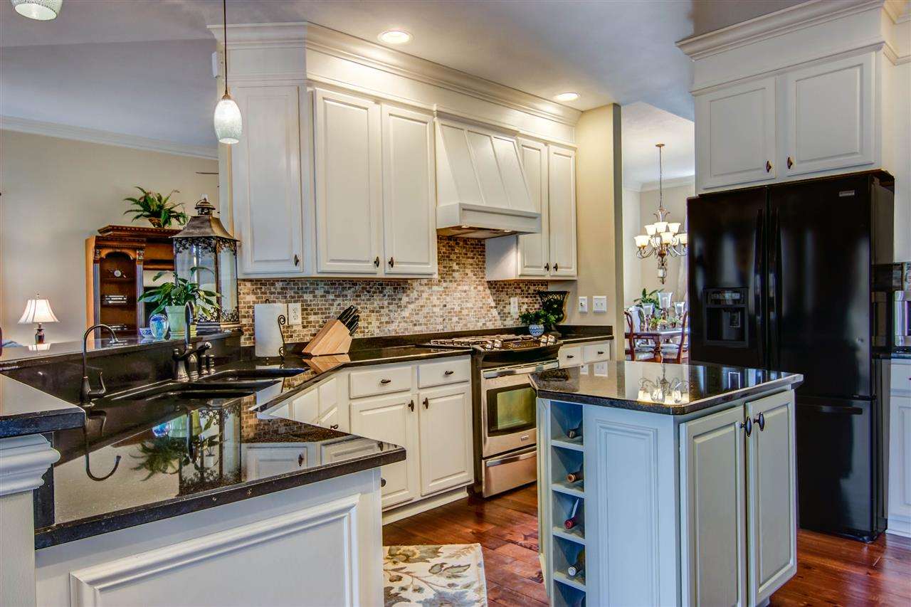 12210 Bellingham Road Caledonia, IL 61011 - Photo 5 of 24 a kitchen with a sink stove and refrigerator