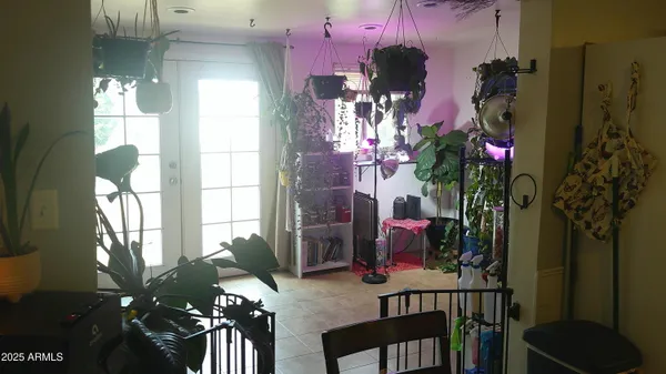 a room with a mirror on dresser and a table