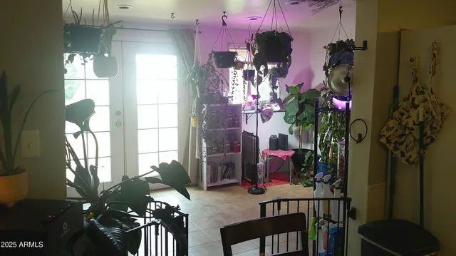 a room with a mirror on dresser and a table