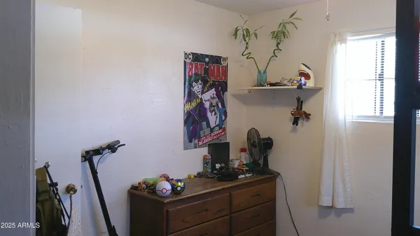 a view of a workspace with furniture and gym equipment