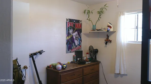 a view of a workspace with furniture and gym equipment