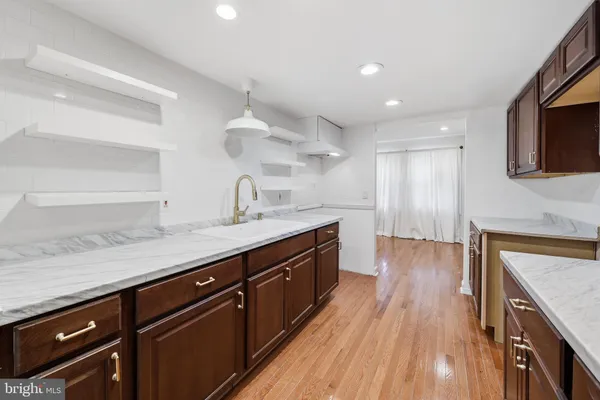 a kitchen with wooden floors and a sink