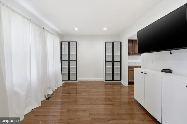 a view of a livingroom with an empty space and a window