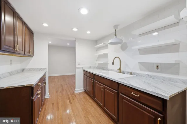a kitchen with a sink a faucet cabinets and stainless steel appliances