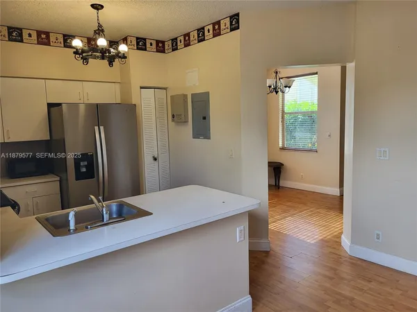 a kitchen with stainless steel appliances a refrigerator and a sink