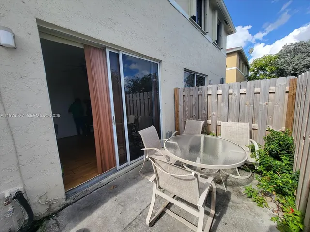 a table and chairs in a patio of the house