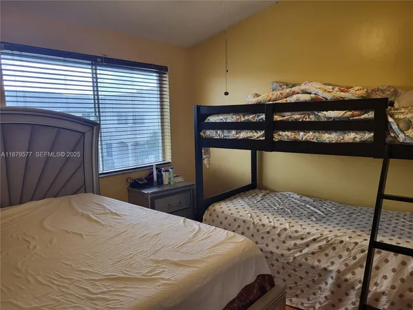 a bedroom with a bed and chair