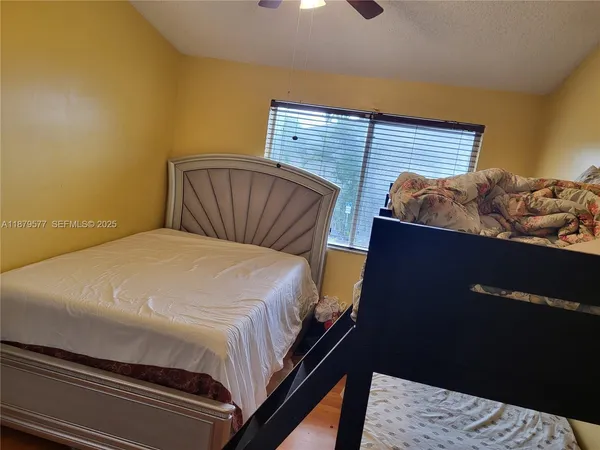 a bed sitting in a bedroom next to a window