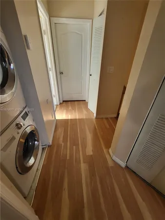 a view of a hallway with washer and dryer