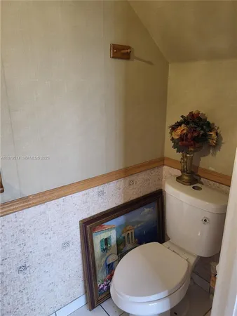 a white toilet sitting next to a bathroom sink