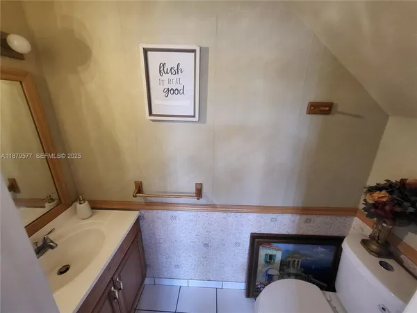a bathroom with a sink toilet and vanity