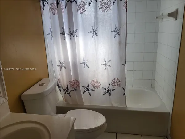 a bathroom with a bathtub and shower