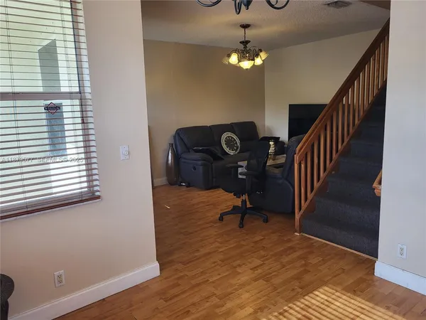 a view of a livingroom with furniture and staircase