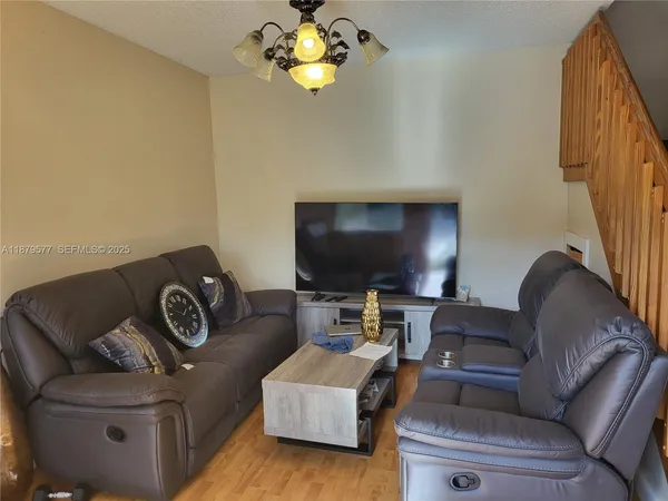 a living room with furniture and a flat screen tv