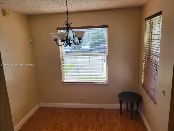 a view of a room with wooden floor and windows