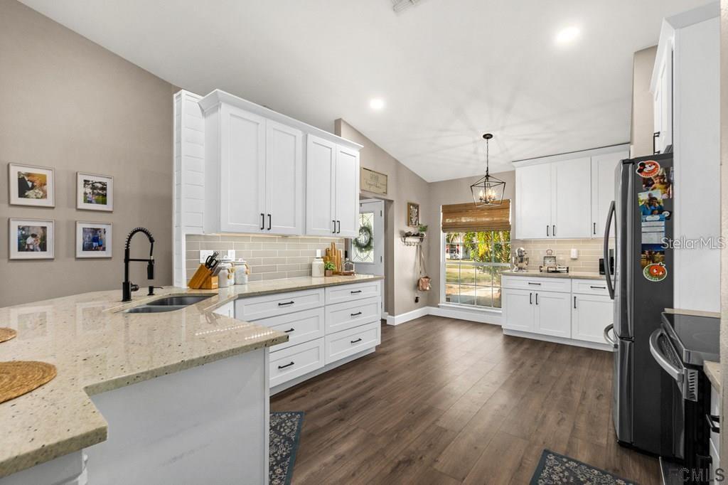a large white kitchen with cabinets