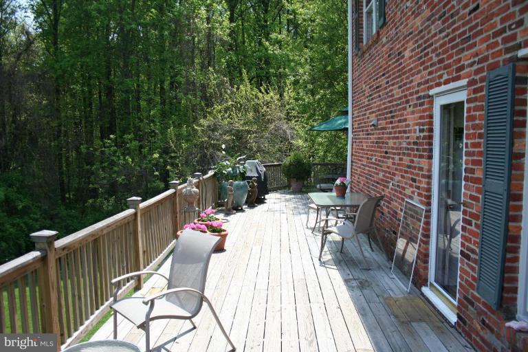 13703 Harcum Road Phoenix, MD 21131 - Photo 10 of 20 a balcony with wooden floor and outdoor seating
