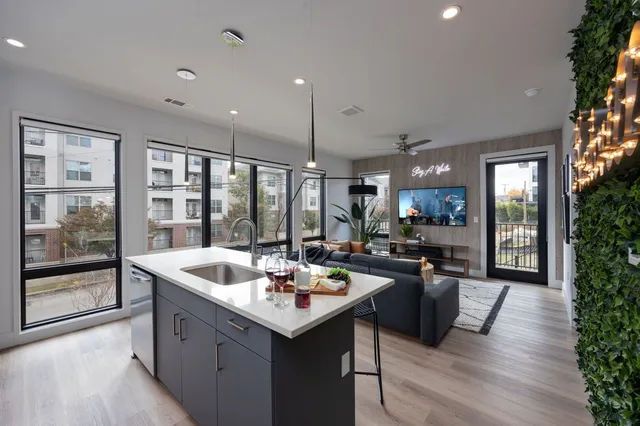 a kitchen with counter top space a sink appliances and cabinets