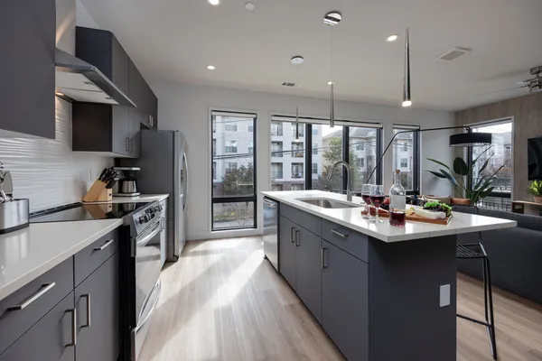 a kitchen with counter top space stainless steel appliances and cabinets