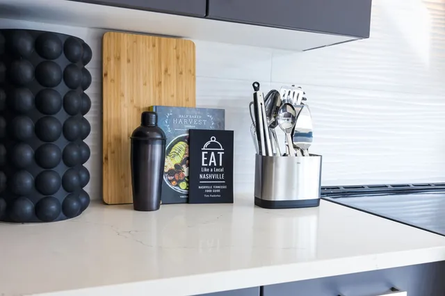 a bedroom with a bed wooden floor and lamp
