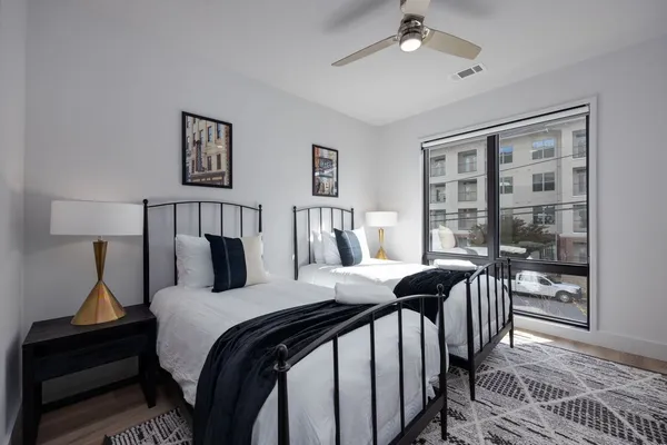 a bedroom with a bed and wooden floor