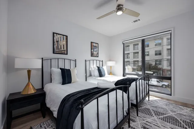 a bedroom with a bed and wooden floor