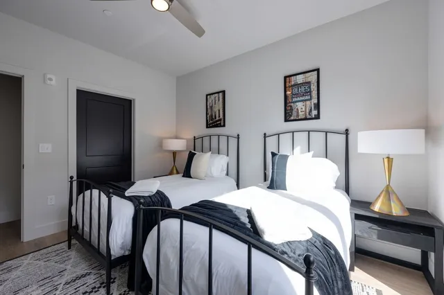 a bathroom with a double vanity sink toilet and shower