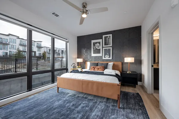 a bedroom with a large bed and a large window