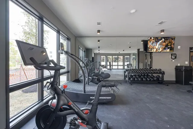 a gym room with lots of gym equipment
