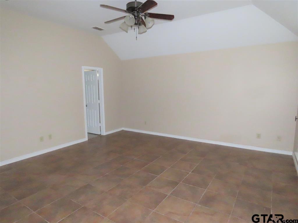 21206 Altuda Lane Flint, TX 75762 - Photo 11 of 13 an empty room with a empty space and a ceiling fan