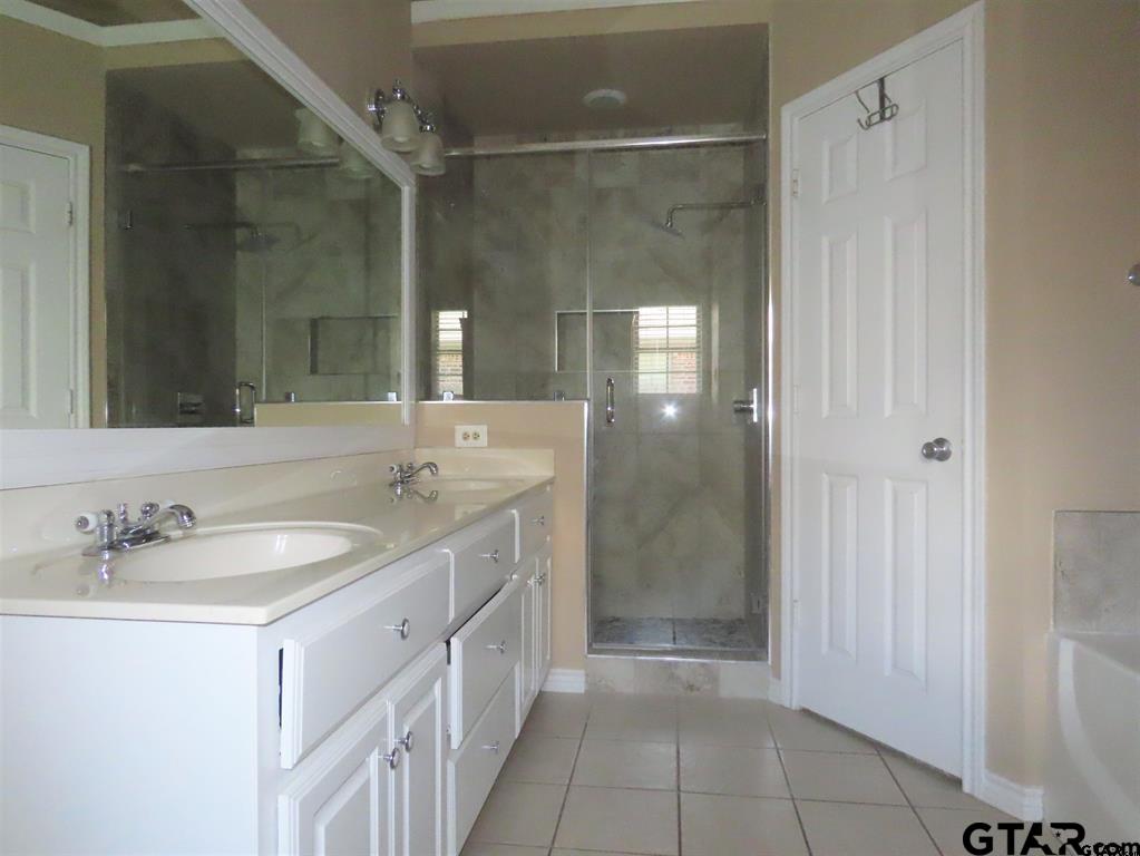 21206 Altuda Lane Flint, TX 75762 - Photo 12 of 13 a spacious bathroom with a shower sink and mirror