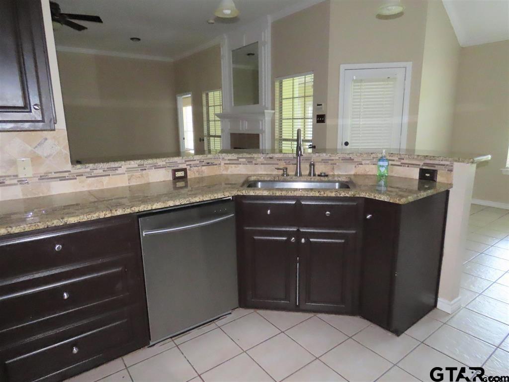 21206 Altuda Lane Flint, TX 75762 - Photo 7 of 13 a kitchen with a sink and a wooden cabinets