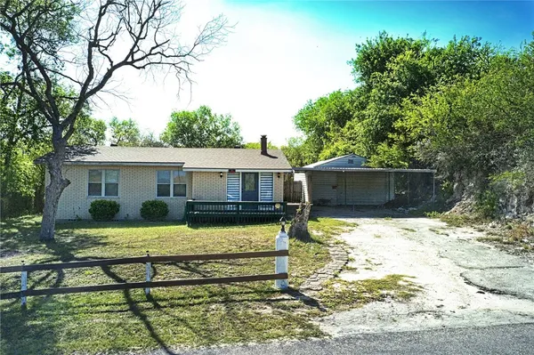 a view of a house with a yard chairs and floor to ceiling window