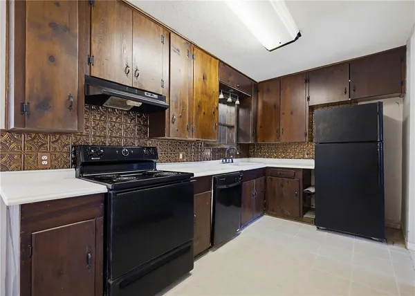 a kitchen with stainless steel appliances granite countertop a sink stove and cabinets