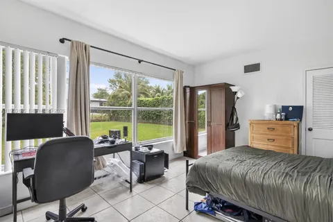 a bed room with a bed and a chair