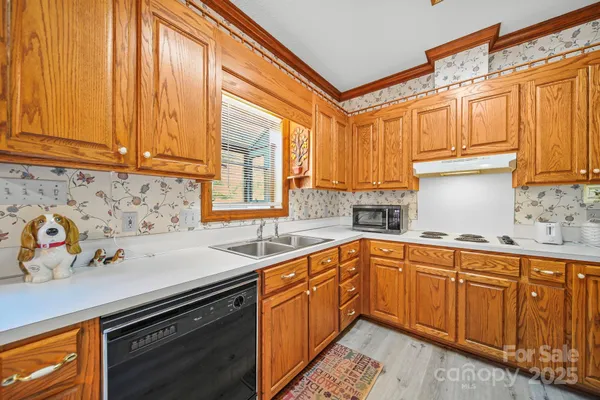 a kitchen with a sink stove and cabinets