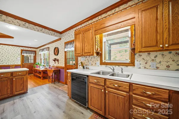 a kitchen with lots of counter top space and wooden floor