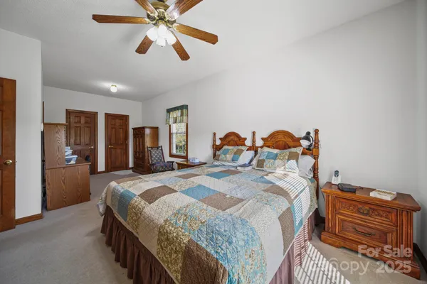 a bed room with a bed and a chandelier